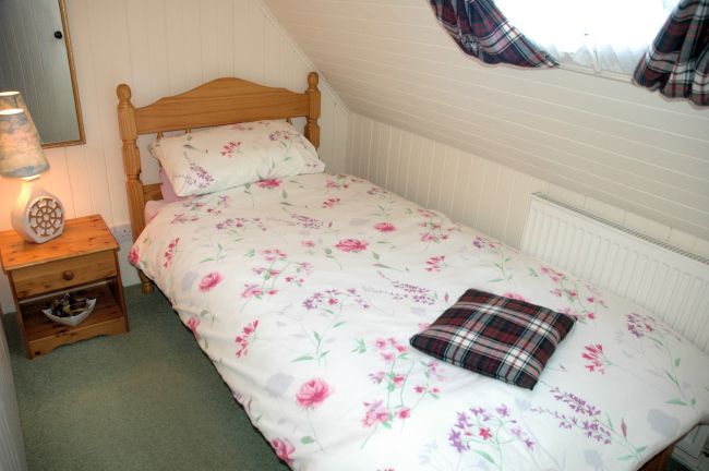 The single bedroom in Bruaich Cottage, Lochcarron, is small but comfortable and has a full-size single bed.