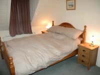 The bedrooms have pine-lined walls and ceilings and are cosy and welcoming. There are superb views from the bedroom windows.