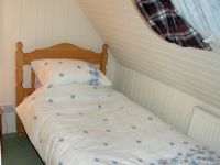 The single bedroom is small but comfortable and has a full-size single bed. It is an ideal room for a youngster or teenager.